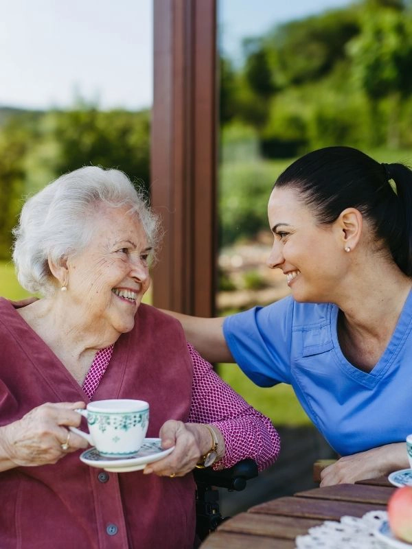 elderly having tea with caregiver