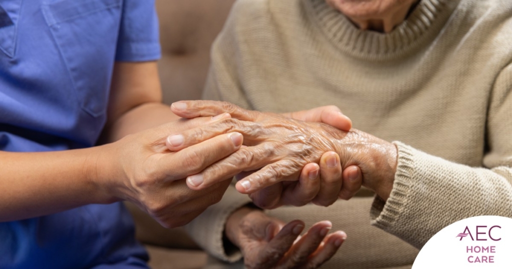 A care provider examines an older adult’s fingers, representing what would happen in an examination for rheumatoid arthritis.