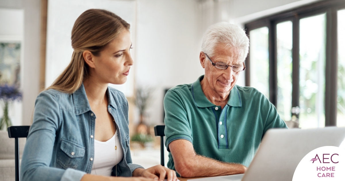 Adult daughter and senior father talking at a kitchen table while comparing home care vs assisted living
